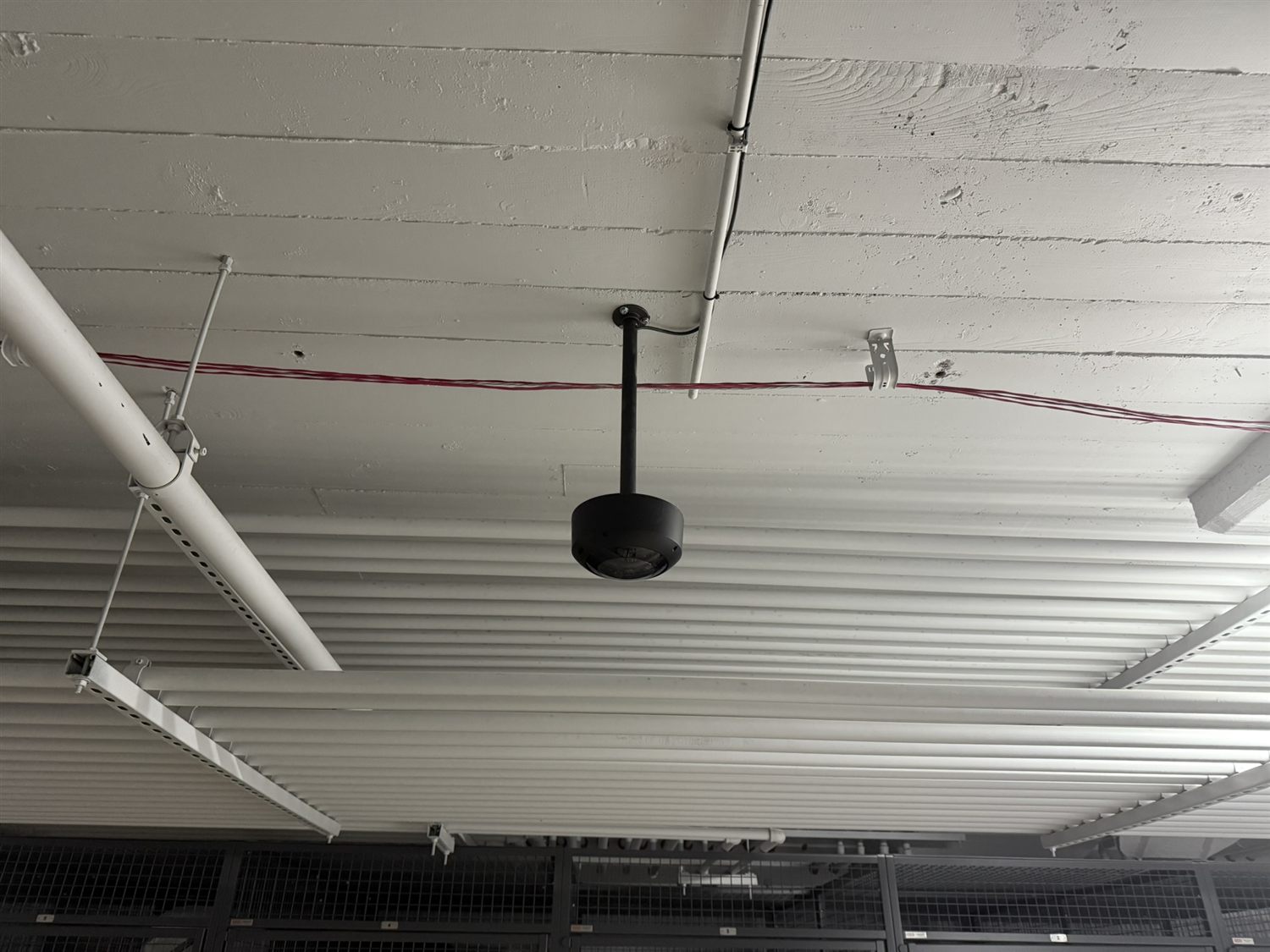 Pendant-mounted security camera installed in a warehouse