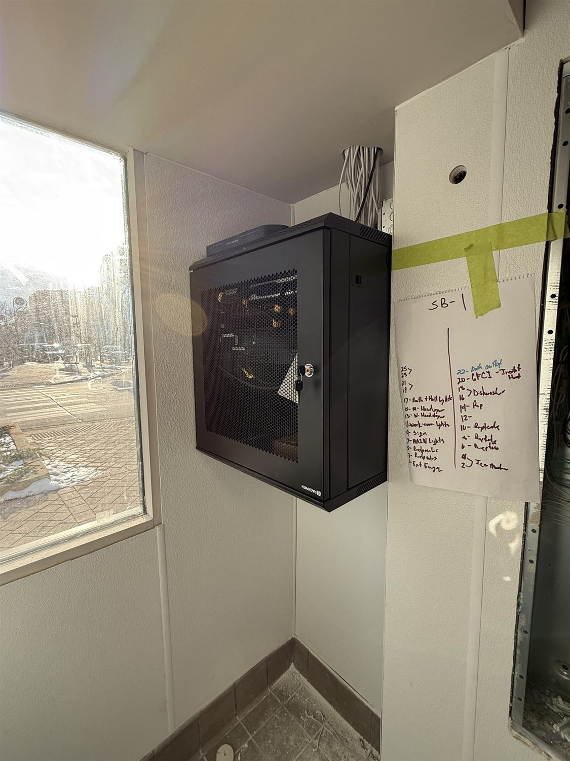 Wall-mounted network cabinet with networking equipment